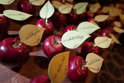 For another idea using apples, the National Association for Catering and Events 2012 gala in Washington had a 'once upon a time' theme, with details from story books—including calligraphy seating cards that nodded to the poisoned apple in Snow White and the Seven Dwarfs.