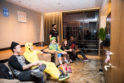 The producers looked to use NeueHouse's variety of spaces to encourage guests to explore the venue and the art experiences offered at both events. That included using a conference room for karaoke at the sleepover and Matt Jones and Kadar Brock's video game matches dubbed 'Smash Bros Challengr' (pictured).