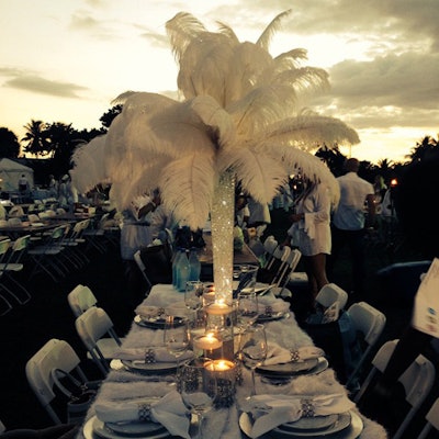 Guests supplied their own tabletop decor for the event, which gave each table a different look. A centerpiece of ostrich feathers helped create a Roaring '20s-style setting.