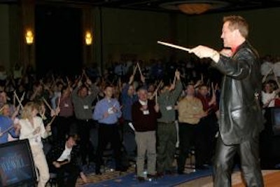 Marvelless Mark gets audience members on their feet as part of his motivational presentation 'Rhythms in Business.'