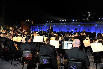 At around 8 p.m., 35 musicians emerged, taking their spots in a makeshift 'orchestra pit.' Their commencement marked the start of the evening's daredevil festivities. 'The idea was to create a modern 'romantic and rough' performance to reveal the survival kit,' said Bureau Betak's Alex de Betak.