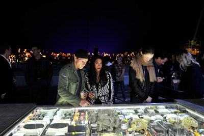 The dark, stark ambience of the event allowed the celebratory object—a $12,500 Ulysses Tier 1 disaster relief kit—to glow bright atop the vast roof of the Just One Eye store on Romaine Street in Los Angeles (the Art Deco building formerly owned and inhabited by Howard Hughes).