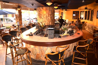 Patio bar area offers table seating surrounding the casual bar atmosphere: the patio is outdoors but covered and temperature managed
