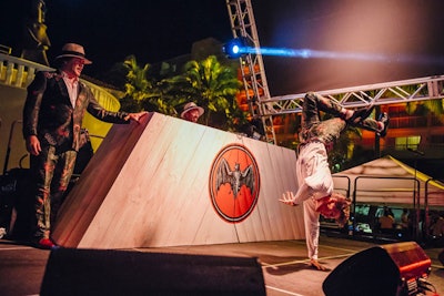 As part of Bacardi's branding activation, two custom triangle pool stages were built and featured the rum maker's bat emblem emblazoned on the wooden façade of the DJ booth. The booths were made of truss covered with a whitewashed wood, and a local Puerto Rican graffiti artist was brought in to paint the Bacardi triangle on the surface.