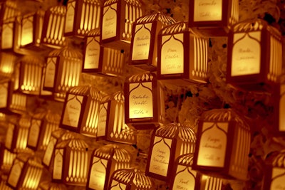 At the luxury wedding summit Engage!13, Gifts for the Good Life used glowing birdcage lanterns as escort cards, which guests pulled from Todd Events' live hydrangea wall at the closing gala.