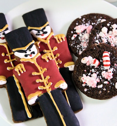 Dark chocolate cookies with crushed peppermint candies and gingerbread cookies decorated with vanilla icing, by Along Came Mary in Los Angeles