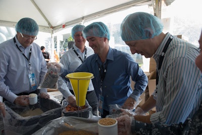 Attendees worked together to package meals on the first day of the conference.