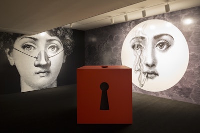 Iconic Fornasetti drawings showcasing smell were applied to the walls of another gallery in the concrete building. From inside a large keyhole cabinet—another classic Fornasetti object—Valentino's Assoluto fragrance wafted out.