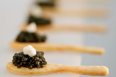 Instead of traditional mother-of-pearl spoons, Peter Callahan serves dollops of caviar on tasty flatware made of Parmesan cracker dough, topped with crème fraîche and accompanied by a chilled shot of vodka.