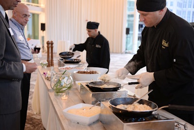 An action station, such as Puff 'n Stuff Catering's risotto bar, allows guests to customize their food and watch it being prepared.