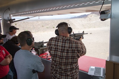 Team members support each other from the spectator area just outside the shooting stations