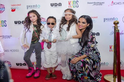 Organizer Albania Rosario Posing with Child Designer and Models