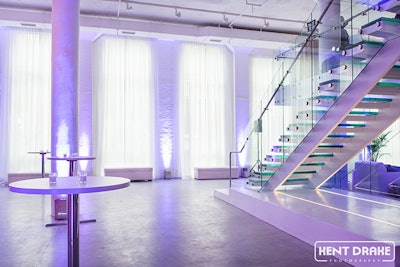 The architectural glass Staircase leads to a mezzanine overlooking the main floor of Chez