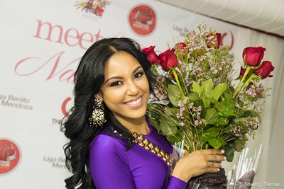 Nabila Tapia of Univision's Nuestra Belleza Latina Poses with roses from a fan