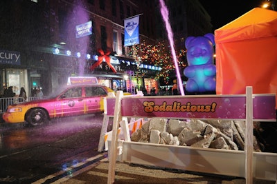 A spray of purple soda covered a New York taxi as part of the performance introducing Candy Crush Soda Saga. Barricades used in the performance had the event's #Sodalicious hashtag.