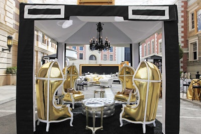 Black & white cabanas provided artistic accents for buffets and furniture groupings. While two oversized gold frames bookended the street around specialty food trucks