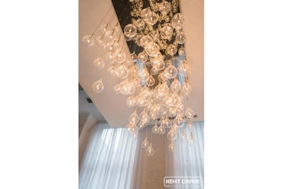 A Contemporary Chandelier Defines The Chez Entrance