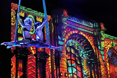 Suspended 40’ overhead, aerialists performed a smoldering dance against a backdrop of animated serpents