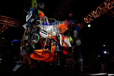 Guests used recycled materials to create artwork hanging from a truss, which was built as guests added to it. A pulley system raised it throughout the night.