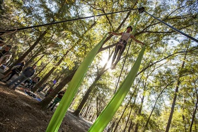 An aerialist performed amid the natural beauty of Spirit Lake's live oak trees.