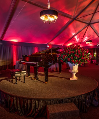 The cocktail tent included red fabric drapes and a center stage with a grand piano for romantic background music.
