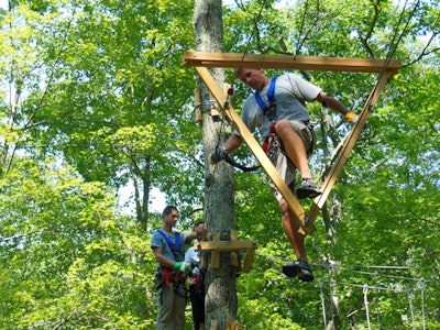 Young adults enjoy a climb at The Adventure Park
