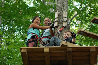 A few climbers signal their enthusiasm while on a tree platform