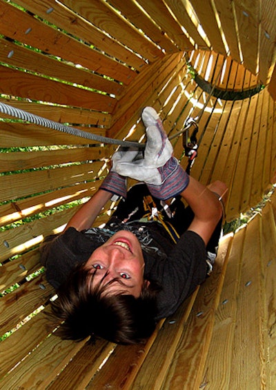 Climbing through a barrel element at The Adventure Park