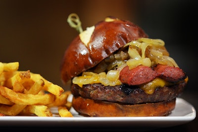 To pay homage to the visiting players, Barclays Center and Levy Restaurants, the venue’s food and beverage partner, launched the first-ever All-Star Taste food program. The menu featured classic dishes inspired by N.B.A. cities, as well as those served at arenas around the league, such as the Chicago Bulls' Mad House Burger topped with a Polish sausage, caramelized onions, and American cheese and served on a pretzel roll (pictured); Los Angeles Lakers' fish tacos with beer-battered cod, cilantro coleslaw, and pico de gallo; and Ignite Bites from the Phoenix Suns—spicy habanero popcorn chicken bites served with buttermilk agave dip. Fans could chow down on the specialty items during the All-Star events Friday to Sunday.