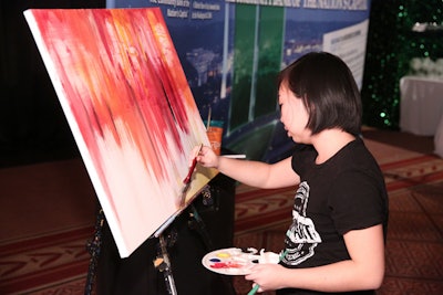 A painter worked on an oil-on-canvas design near the United Bank bar throughout the night.