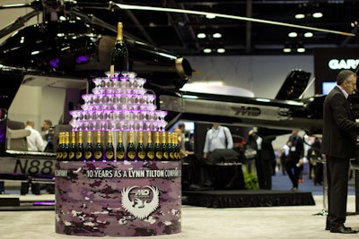 MD Helicopter created a display of champagne glasses and bottles etched with the company logo to commemorate its 10th anniversary under the leadership of C.E.O. Lynn Tilton.