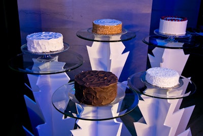 The five birthday cakes were arranged on fabricated pedestals intended to evoke a stalagmite.