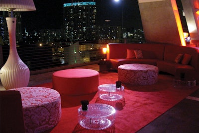 Custom red lounge with Red Horse patterned ottomans and Panier Tables for event at 1111 Lincoln Rd