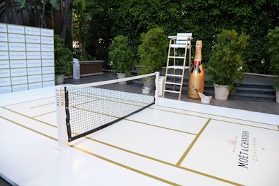 A giant prop bottle of champagne stood by the mini tennis court.