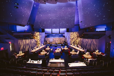 Performance hall plated dinner on the flat stage, no retraction with immersive projection.