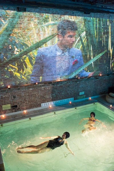 On February 25, Ted Baker showcased its latest collection of womenswear, menswear, and accessories at Aire Ancient Baths in TriBeCa. To ensure the comfort of guests and anyone else in the bathhouse, the team had the venue cool down the space and the pools. On the wall above one of the baths, the organizers projected video from the campaign.