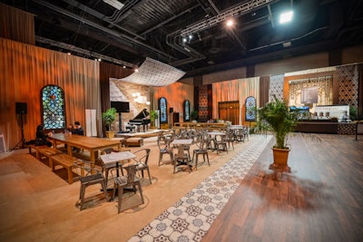 The AIPAC Coffee House was designed to evoke a street café in Israel where attendees could get coffee or a light snack. The wood and antique tile flooring were actually designs that Hargrove printed onto vinyl and applied to flex flooring to give the look of luxe materials without the cost.