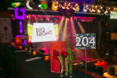 Splashes of neon on the table numbers were part of the 1990s theme. Another decor element, red tulips, spruced up areas throughout the venue.
