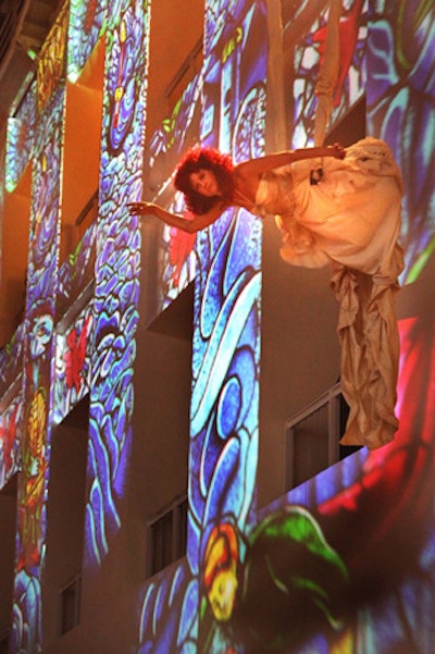An aerialist floated adjacent to a large-scale projection of Marc Chagall stained-glass artwork, which covered an entire two-story wall in the main building.