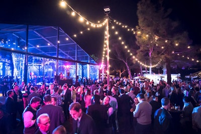 Bankers filled the party space adjacent to the open-flow tent under carnival stringer lights.