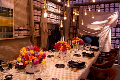 The area sponsored by Ralph Lauren Home highlighted the brand's paint collection with paint cans filled with colorful blooms as centerpieces, paint-dipped wooden stirrers as place cards, and drop cloths and paint swatches as wall decor.