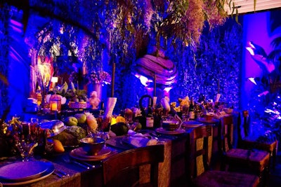 A New Orleans garden dinner party, à la Midnight in the Garden of Good and Evil, was the theme of The New York Times dining space, designed by Robert Passal Interior and Architectural Design. The lush environment, which even included a mossy room spray, featured Passal's dinnerware collaboration with L'objet, along with Bradley Clifford's talon candlesticks and items from Bergdorf Goodman. The 250-year-old dining chairs were retrieved from an assembly hall in England.