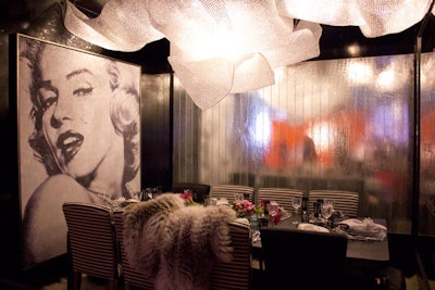 Inspired by Marilyn Monroe, Manhattan magazine and Fendi Casa's booth featured a glamorous table with lots of reflected light and sparkly mesh-covered fixtures.