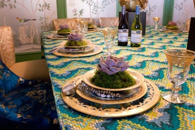 Inspired by Rio de Janeiro, designer Corey Damen Jenkins created a dining space for Beacon Hill with sophisticated and bohemian elements, including a mix of luxe dining chairs and a colorful mosaic textile for the tabletop.