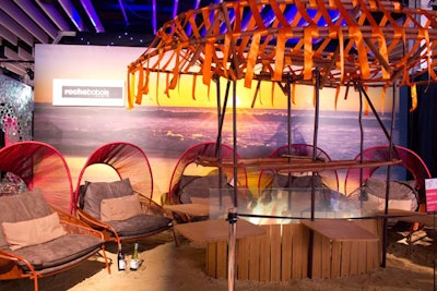 Stephen Burks, the designer of Roche Bobois Paris's Traveler chair, also created the company's installation, which was based around his furniture. The chairs evoked a cozy camp-like feel, creating an outdoor pavilion indoors with a projected fire by Levy Lighting.