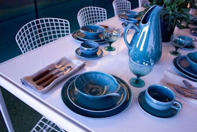 Gensler and 3form brought the outdoors in with Astroturf as a floor covering, white wire chairs, and vivid blue tableware. Images of a modern house served as the backdrop.