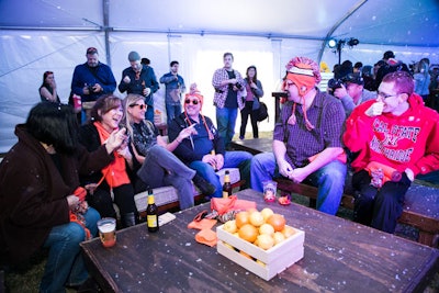 Citrus fruits in mini crates topped tables, and guests wore branded hats as giveaways.