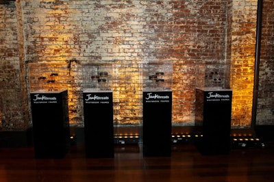 Display cases for the sunglasses comprised clear cubes atop clean black pedestals. Yellow lighting maintained the event's color scheme.