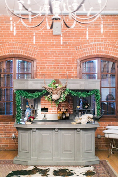 Taxidermy and greenery decked a bar designed by Karson Butler, where bartenders wore vintage gear reminiscent of the Old West and served honey whiskey lemonade and sangria from 24 Carrots.