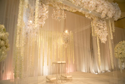 'For a glamorous wedding ceremony, a plush canopy of 8,000 phalaenopsis orchid blooms and dendrobium orchid strands created a luxurious and magical setting.'